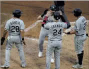  ?? JIM MONE — THE ASSOCIATED PRESS ?? White Sox’s Danny Mendrick, center back, is greeted after his grand slam off Twins pitcher Derek Law on Monday.