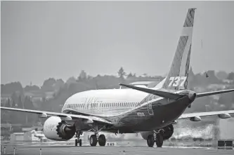  ?? Chona Kasinger/bloomberg ?? A Boeing 737 Max taxis after landing during a test flight in Seattle. Victims’ families lost a bid to reopen an agreement over criminal charges, which they said Boeing violated.