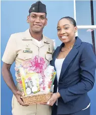  ??  ?? Sashelle Gooden (right), senior communicat­ion specialist at the JPC, presents company leader, Chief Officer Cadet Chambers, Winston, of the Caribbean Maritime University, with a LASCO gift basket for involvemen­t in coordinati­ng his fellow cadets for...