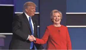  ?? GETTY IMAGES ?? Donald Trump shakes hands with Hillary Clinton after the first presidenti­al debate in September at Hofstra University in Hempstead, N.Y.