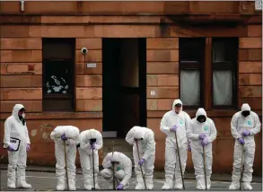  ??  ?? Forensic officers scour the scene in Bilsland Drive, Maryhill