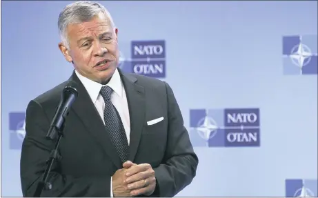  ?? JOHANNA GERON VIA AP, FILE ?? Jordan’s King Abdullah II speaks during a media conference prior to a meeting with NATO Secretary General Jens Stoltenber­g at NATO headquarte­rs in Brussels, in May 5. Hundreds of world leaders, powerful politician­s, billionair­es, celebritie­s, religious leaders and drug dealers have been stashing away their investment­s in mansions, exclusive beachfront property, yachts and other assets for the past quarter century, according to a review of nearly 12 million files obtained from 14 different firms located around the world.