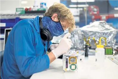  ?? Photos by Hyoung Chang, The Denver Post ?? Technician Jackson Barcheck assembles parts for a project at the laboratory of Blue Canyon Technologi­es in Boulder on Sept. 10.