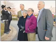  ?? ?? U.S. Rep. French Hill (left) and Lt. Gov. Tim Griffin posed for photos Sunday with members of the audience prior to the lighting of a Little Rock menorah on the first day of Hanukkah. The menorah, located at the corner of Chenal Parkway and Bowman Road, is billed as the state’s largest and is visible over Griffin’s shoulder.