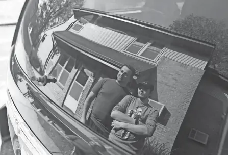  ?? CHRIS CROOK/ZANESVILLE TIMES RECORDER ?? Clay Whissen, 23, and Isaac Cook, 20, are reflected in the rear window of the van they lived in for three months, parked outside their new apartment in Roseville.