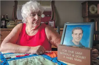  ?? DAVE SIDAWAY ?? Janet Torge holds a photo of son Sam Lazarus, who died from malaria in 2004 while serving as a volunteer teacher in Ghana.