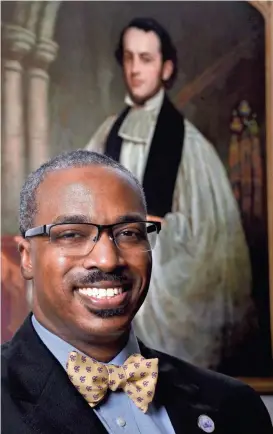  ?? LARRY MCCORMACK/THE TENNESSEAN ?? President and Vice Chancellor Reuben Brigety II is the first African American to serve in that post at the University of the South in Sewanee, Tenn. Behind him is a portrait of the first vice chancellor there, Charles Todd Quintard, who served from 1867 to 1872.