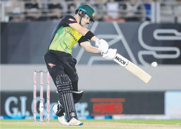  ?? Picture: AFP PHOTO ?? Palmerston product D'Arcy Short unleashes during his match-turning innings against the Kiwis at Eden Park in Auckland on Friday