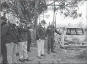  ?? —AFP ?? US President Donald Trump looks at the remains of a minivan burnt in the wildfires in Malibu, California, on Saturday.