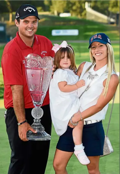  ?? — AP ?? Look at what I’ve got: Patrick Reed holding The Barclays trophy as he poses with his wife Justine and daughter Windsor-Wells in Farmingdal­e, New york, on sunday.