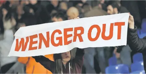  ??  ?? Arsenal fan holds up a message directed at manager Arsene Wenger during the match against Crystal Palace at Selhurst Park. — Reuters photo