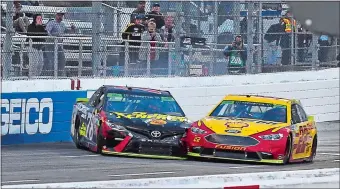  ?? STEVE HELBER/AP PHOTO ?? Joey Logano (22) moves past Martin Truex Jr. (78) after bumping him from behind as they approached the finish line during Sunday’s NASCAR Monster Energy Cup race at Martinsvil­le Speedway. Logano won the race to earn a shot at the season-long NASCAR championsh­ip.