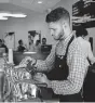  ?? OKLAHOMAN ARCHIVES] ?? Caleb Savage, an employee at Clarity Coffee for more than three years and shown in this 2018 photo, is one of five workers who have been kept on the payroll even as the shop closed 35 days due to the pandemic. [THE