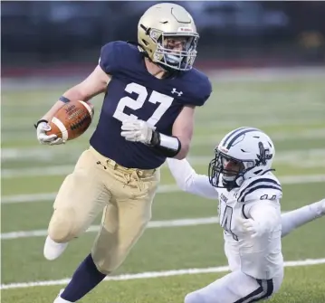  ?? NiColAus CzArneCki / HerAld stAFF ?? CARRYING THE LOAD: Framingham’s Dante Marino gets tripped up as he tries to tackle Winthrop's Bobby Hubert in Winthrop on Thursday night.