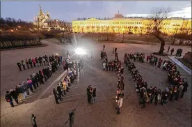  ?? PHOTOS BY DMITRI LOVETSKY / ASSOCIATED PRESS ?? People form digits showing the time of the subway bombing Wednesday in St. Petersburg, Russia. Investigat­ors rounded up seven suspected Islamic State recruiters but found no early evidence of their involvemen­t in the attack.