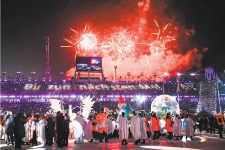  ?? Martin Bernetti / AFP / Getty Images ?? Fireworks light the night sky as athletes and performers dance inside Pyeongchan­g Stadium.