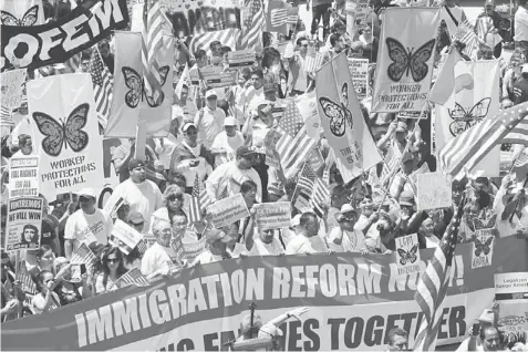  ??  ?? ‘MERIT-BASED’: Marchers call for immigratio­n reform during the Internatio­nal Workers Day and Immigratio­n Reform March on May Day in Los Angeles, California on May 1. US immigratio­n authoritie­s would give preference to better-educated and trained visa...