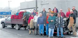  ?? POSTMEDIA NETWORK FILES ?? Standing beside a truck loaded up with the old seats on Jan. 9, 2013 are volunteers helping to revitalize the Aron Theatre in Campbellfo­rd