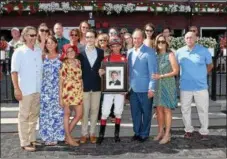  ?? PHOTO ADAM COGLIANESE/ NYRA ?? Michael and Regina Stewart (center, right) stand with winning jockey John Velasquez in the winner’s circle at Saratoga Race Course after Thursday’s sixth race, ‘Rememberin­g Christophe­r ‘Stwez’ Stewart 5th annual Memorial race won by Alberobell­o.