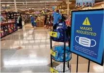  ?? MATT KEMPNER / MATTHEW.KEMPNER@AJC.COM ?? Kroger has installed signs at its stores in metro Atlanta urging customers to wear masks. Meanwhile, some communitie­s around Georgia have begun mandating mask use by the general public in some cases.