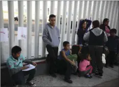  ?? AP PHOTO/EMILIO ESPEJEL ?? In this Sept. 13, 2019, file photo, Central American migrants wait to see if their number will be called to cross the border and apply for asylum in the United States, at the El Chaparral border crossing in Tijuana, Mexico.