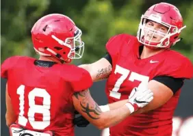  ?? AP PHOTO/JOSHUA L. JONES ?? Georgia tight end Isaac Nauta, left, and Georgia offensive lineman Cade Mays run a drill during a practice in Athens, Ga., on Aug. 16.