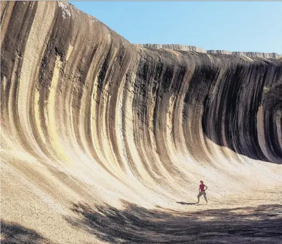  ?? James Hutchison ?? THE APTLY named Wave Rock, a prehistori­c formation that stands 49 feet tall outside the outpost of Hyden in Western Australia, took shape over millions of years.