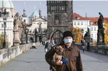  ?? Petr David Josek / Associated Press ?? In an attempt to slow infections, Czech officials announced a ban on free movement and a closure of many stores.