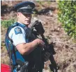  ??  ?? Police outside accused mass murderer Brenton Tarrant’s house in Dunedin