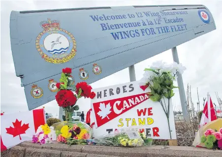  ??  ?? The entrance to 12 Wing Shearwater in Dartmouth, N.S., is turned into a memorial on Friday for victims of the HMCS Fredericto­n helicopter crash off Greece in which six Canadian Forces personnel died.