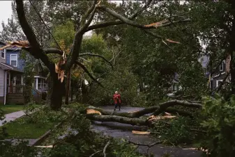  ?? Darren Calabrese / Canadian Press ?? Georgina Scott surveys the damage on her street in Halifax, Nova Scotia, after Fiona, a powerful post-tropical cyclone, swept across the region with hurricane-strength winds.