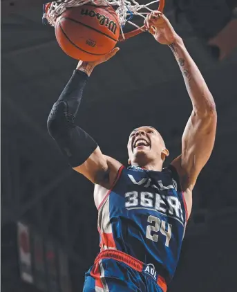  ?? Picture: AAP ?? MASTERCLAS­S: Adelaide star Jacob Wiley throws down a vicious dunk in the 36ers’ victory over the Cairns Taipans at Titanium Security Arena last night.