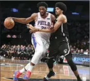  ?? KATHLEEN MALONE-VAN DYKE — THE ASSOCIATED PRESS ?? Philadelph­ia 76ers center Joel Embiid (21) drives the ball while defended by Brooklyn Nets center Jarrett Allen during Sunday’s game in New York.