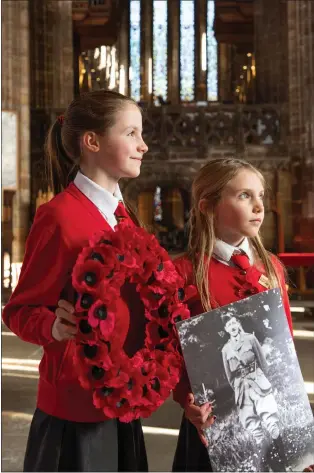  ??  ?? Iona and Torrin Scott Elliot at Glasgow Cathedral with a picture of their great-great grandfathe­r Picture: Mark Gibson