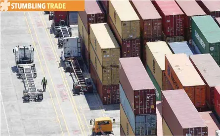  ?? — Reuters ?? Workers stack empty shipping containers for storage at Wando Welch Terminal operated by the South Carolina Ports Authority in Mount Pleasant, South Carolina, US.