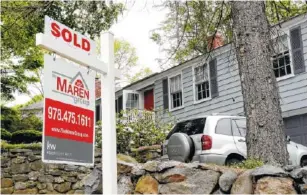  ?? ASSOCIATED PRESS FILE PHOTO ?? A sold sign is placed in front of a house in Andover, Mass.