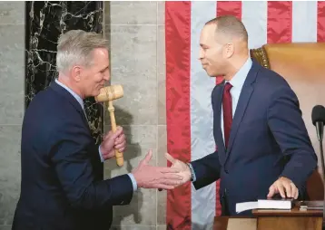  ?? ANDREW HARNIK/AP ?? Rep. Kevin McCarthy is given the speaker’s gavel by House Minority Leader Hakeem Jeffries early Saturday.