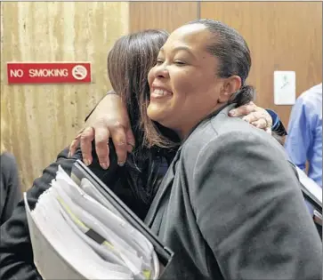  ?? Jay L. Clendenin Los Angeles Times ?? SAMARA HERARD, right, hugs Deputy Dist. Atty Beth Silverman before speaking to the media after the verdict. Herard is the sister of the youngest victim, Princess Berthomieu­x, who was 15 when she was killed.