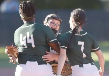  ?? STAFF PHOTO BY MATT HAMILTON ?? Silverdale Baptist Academy softball players Amare Starling (44) and Emry Masterson (7) congratula­te pitcher Ella Cunningham after the Lady Seahawks won 5-0 at Baylor on May 2, 2023. Silverdale and Baylor both won TSSAA state titles at the 2023 Spring Fling, as did the McCallie tennis team.