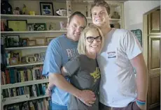  ??  ?? THE HEISMAN TROPHY front-runner poses with his father, Mike, and mother, Chris, at their home. Sam was usually quiet as a child.