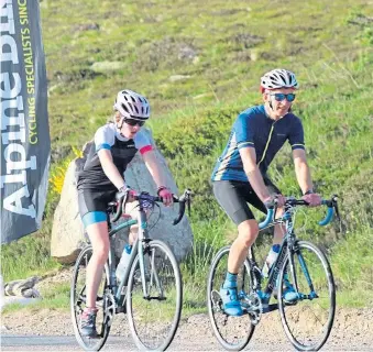  ??  ?? ON TRACK: Isla Easto and her father Paul, who are setting out on a gruelling cycling fundraiser in memory of her grandfathe­r Kenneth, right, seen with Isla as a baby