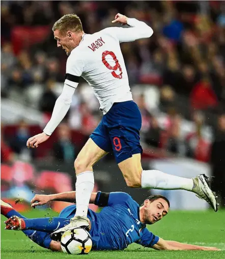  ??  ?? Going all out: Italy midfielder Mattia De Sciglio slides in to make a vital tackle on England striker Jamie Vardy during the friendly at Wembley on Tuesday. — AFP