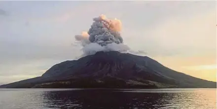  ?? REUTERS PIC ?? Mount Ruang spewing volcanic ash, as seen from Tagulandan­g in Sitaro Islands Regency, North Sulawesi province, Indonesia, on Friday.