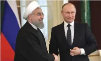  ?? (Reuters) ?? RUSSIAN PRESIDENT Vladimir Putin shakes hands with Iranian President Hassan Rouhani during a joint news conference in Moscow last year.