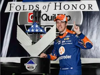  ??  ?? Brad Keselowski poses with the trophy in victory lane after winning a NASCAR Monster Cup series auto race Sunday at Atlanta Motor Speedway in Hampton, Ga. AP PHOTO