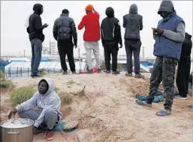  ?? Thibault Vandermers­ch European Pressphoto Agency ?? MANY OF THE MIGRANTS living in “the Jungle” camp in Calais, France, are from Afghanista­n, Iraq and Syria; others are f leeing rampant poverty in Africa.