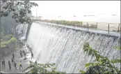  ??  ?? People enjoy themselves as Powai lake overflows after heavy rains lashed the city on Sunday.