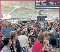  ??  ?? Passengers at Stansted airport yesterday. Left, lightning destroyed the roof of a house in Colchester