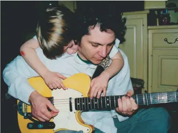  ??  ?? Tweedy picks a Telecaster as his oldest son, Spencer—now 23 and a drummer who recorded the 2014 album Sukierae with his dad—watches.