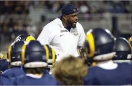  ?? PHOTO BY TRACEY ROMAN ?? Millikan head coach Romeo Pellum will lead his team into action tonight at Veterans Stadium when his Rams try to avenge last season's rout at the hands of Poly.
Online: Coverage of Thursday night's high school football games is at